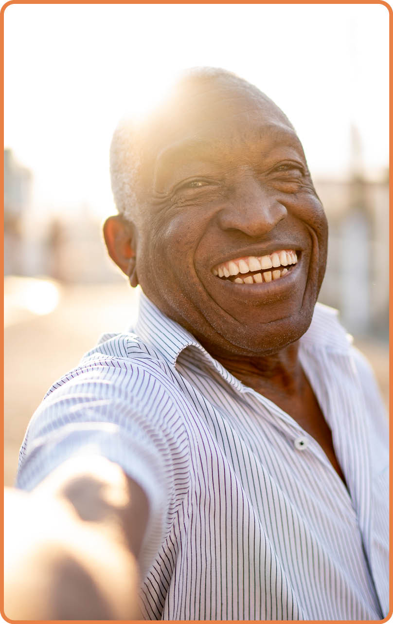 Smiling senior man taking a selfie on the street