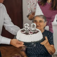grandmother celebrating her 80 birthday with a cake