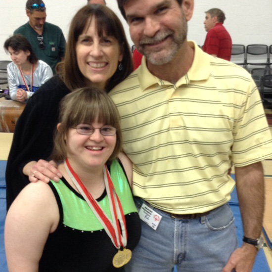 Rey and family posing with award