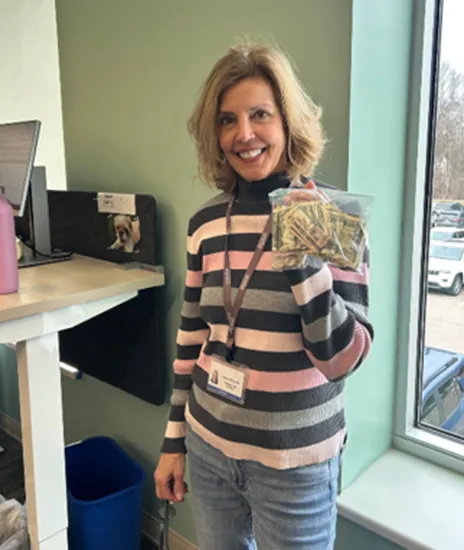 Volunteer holding money they raised for the organization