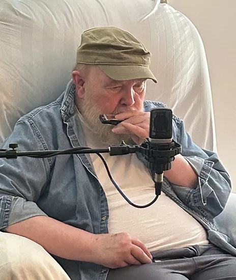 Elderly man playing harmonica