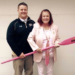Matthew with his mother holding a pink oar with 'Row the Boat' on the blade